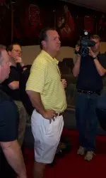 Mark Gottfried goes through jump training as the media look on