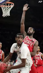 North Carolina State's C.J. Leslie defends Connecticut's DeAndre Daniels during the first half. (AP Photo/Frank Franklin II)