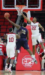 Ralston Turner goes up to block a Queens' shot