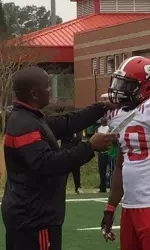 Safeties coach Clayton White with Fr. Freddie Phillips, Jr.