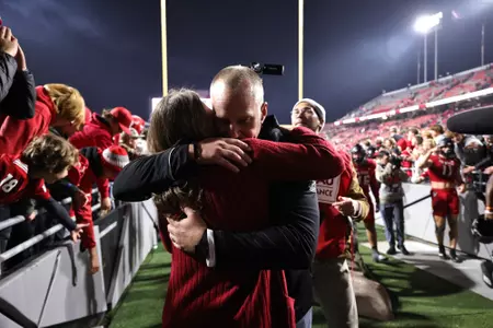 Dave Doeren hugs his wife Sara after becoming the all-time wins leader at NC State