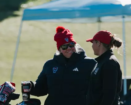 Darby Sligh coaches up Ellie Hildreth before teeing off at the Ruth's Chris Tar Heel Invitational