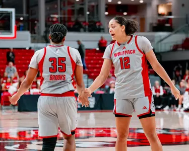 Khamil Pierre and Zoe Brooks high five during game