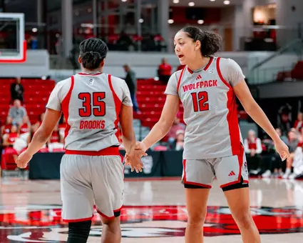 Khamil Pierre and Zoe Brooks high five during game