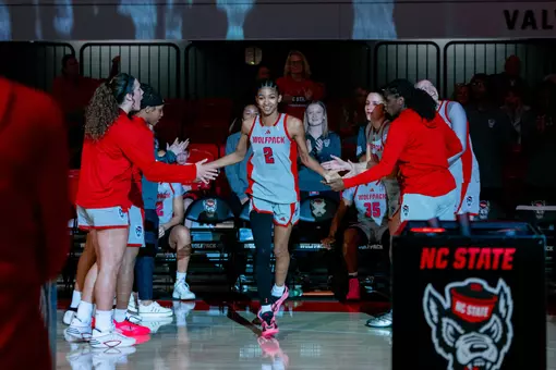 Qadence Samuels claps with her teammates during starting lineup announcements