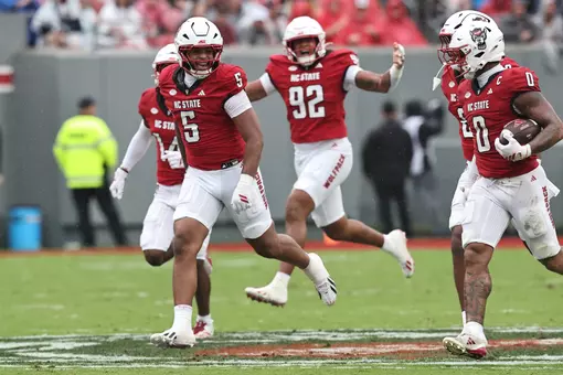 The Pack celebrates one of three Louisville turnovers.
