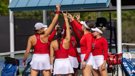 Women's Tennis team in group prior to game