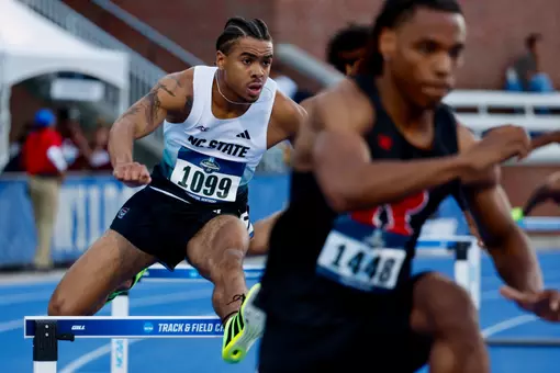 Xavier Branker jumping over a hurdle in the first round of the 400m hurdles at the NCAA East First Round