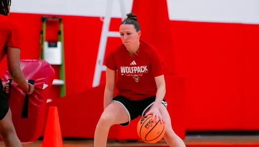 Audrey Eriksen dribbles the basketball at practice