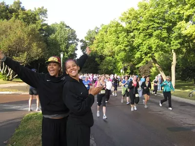 Micaella Riche and Kionna Kellogg cheer for participants during the race.