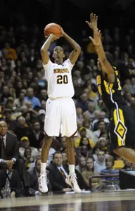 Austin Hollins completed a three-point play to send the game to overtime.