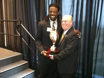 Coach Kill congratulates last year's team MVP MarQueis Gray at the 2011 banquet.