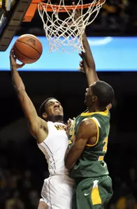 Austin Hollins attempts to go to the basket over North Dakota State's TrayVonn Wright.
