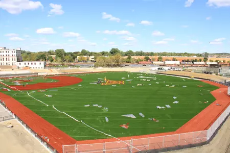 Minnesota 'M' logo getting sewn into the turf field.