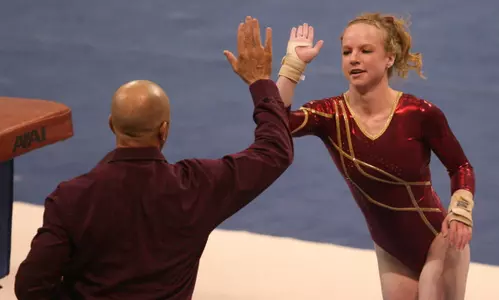 Lindsay Mable tied for first on bars versus Washington.