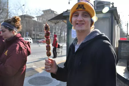 Dan trying some caramelized fruit authentic to Beijing
