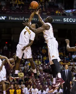 Kevin Dorsey (4) and center Bakary Konate (21) grab a rebound during the first half.