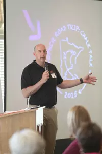 Hugh McCutcheon, who will be on the Maroon Trip this year, addresses a capacity crowd in Rochester at a stop during last year's Gopher Road Trip