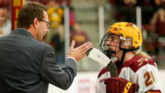 Head Coach Brad Frost givers guidance to Taylor Wente (28)NCAA Hockey: Colgate v Minnesota