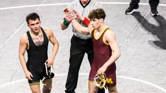 Minnesota's Brandon Morvari, right, has his hand raised after wrestling Iowa's Joey Cruz at 125 pounds during the Soldier Salute college men's wrestling tournament, Friday, Dec. 29, 2023, at Xtream Arena in Coralville, Iowa.