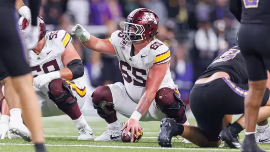 Center Greg Johnson snaps the ball to quarterback Drake Lindsey