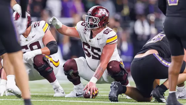 Center Greg Johnson snaps the ball to quarterback Drake Lindsey