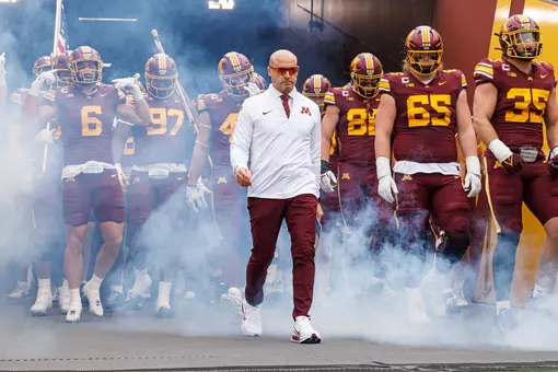 Head Coach P.J. Fleck leads Minnesota onto the field at Huntington Bank Stadium
