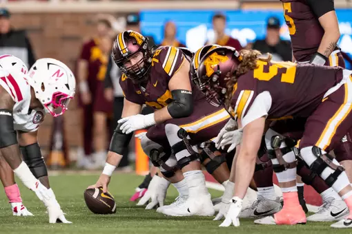 Minnesota center Ashton Beers prepares to snap a ball in a victory against Nebraska in 2025