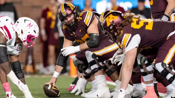 Minnesota center Ashton Beers prepares to snap a ball in a victory against Nebraska in 2025