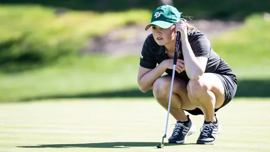 Caroline Cantlay lining up a putt.
