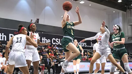 Abbey Ellis from Cal Poly basketball drives at CSUN in a 2020 game (File Photo by David E. Holmes ©))