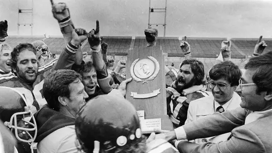 Cal Poly holds up national championship trophy.
