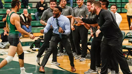 Coach Chris Chionuma celebrates a win by the Mustangs at Mott (Photo by Owen Main ©)