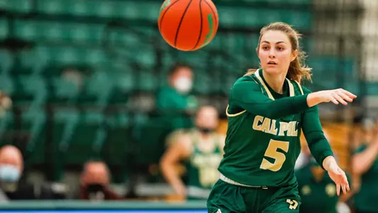 Malia Holt, Mustang guard, makes a pass at Cal Poly (Photo by Owen Main)