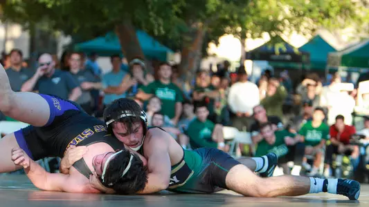 Nathan Tausch wrestles outdoors in 2019.