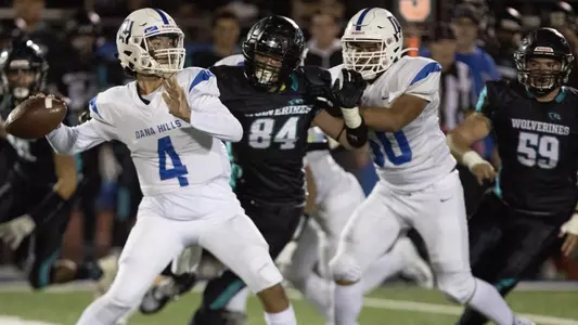 Bo Kelly launches a pass downfield.