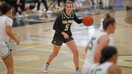 Malia Holt of Cal Poly surveys the defense at the top of the circle (Photo by Owen Main ©)