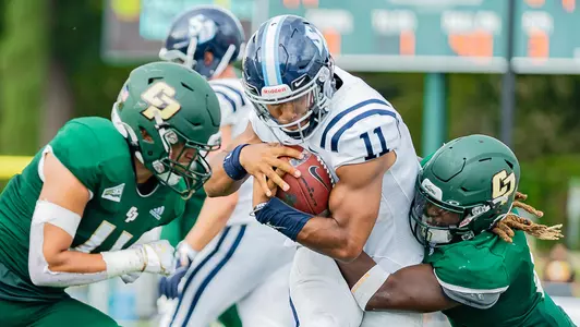 Zach Hernandez and Je'kob Jones tackle the quarterback.