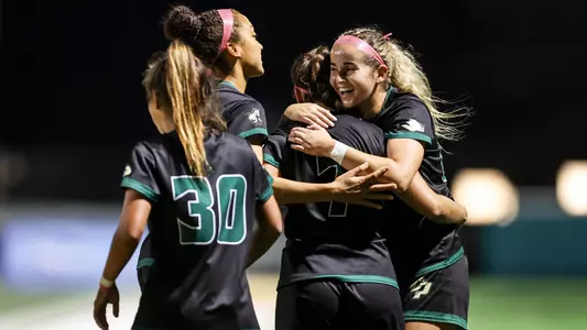 Madison Demijohn hugs Monse after goal, UC Davis, 10-6-22
