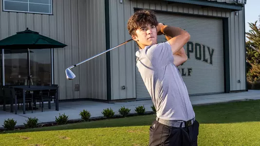 Travis Parrish watches the ball following his drive.