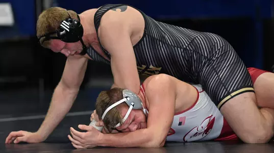 Trevor Tinker wrestles against Lock Haven.