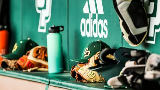 Baggett Stadium dugout with baseball gear.