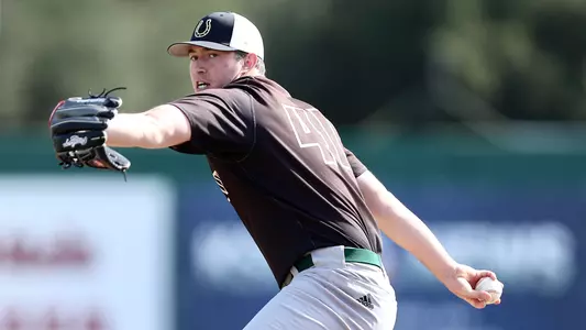Erich Uelmen pitches for alumni squad.
