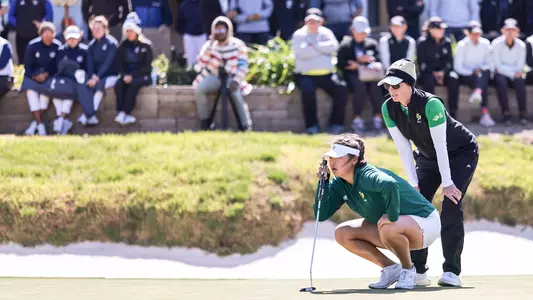 Sofie Aagaard helps Kaylyn Noh line up a putt.