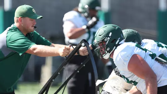 Harry Whitson on the sled for offensive linemen.