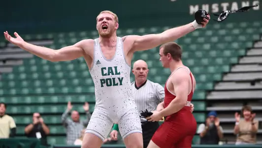 Trevor Tinker celebrates dual meet-clinching win.