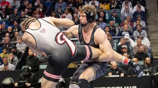 Bernie Truax tries to gain control of Rider's Ethan Laird for a takedown in consolation semifinal match Saturday. Truax earned a 5-2 decision en route to fourth-place finish and third All-American award.