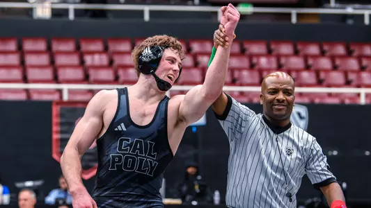 Bernie Truax has his arm raised after winning 197-pound title.
