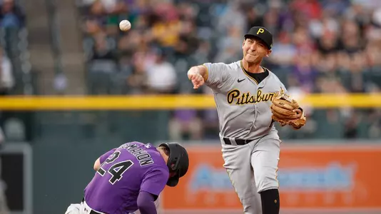 Mark Mathias throws to first base.