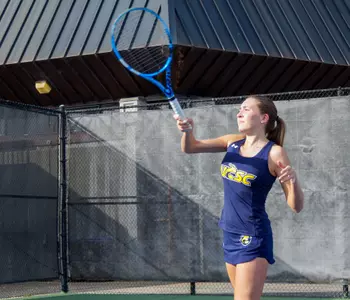 Daniela returns a serve